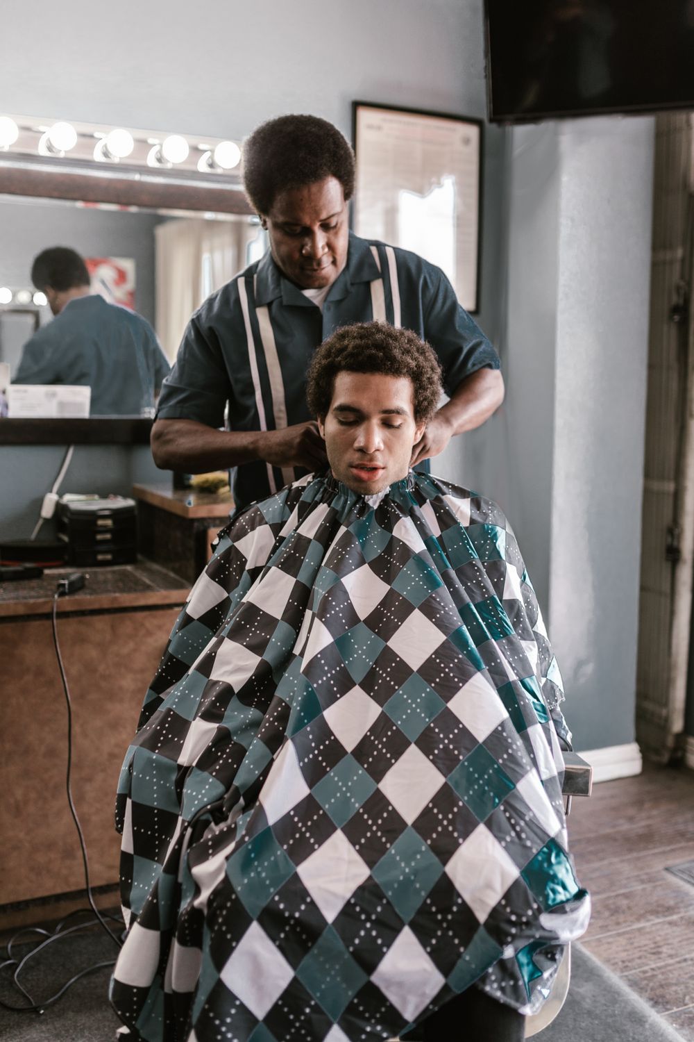 Barber giving a fresh fade haircut